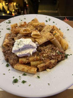 Rigatoni bolognese with seasoned ricotta.