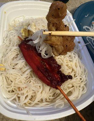 Chow mein fun, chicken skewer, and a piece of black peppered chicken