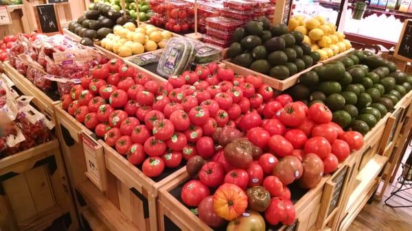 A variety of tomatoes avocados lemons, basil