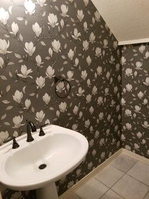 Powder room with floral wallpaper