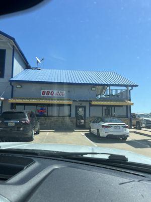 Outside entrance to the right of the gas station.