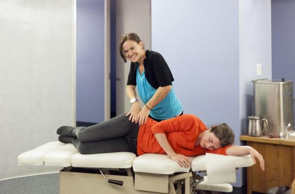 Dr. Megan Thoma - a licensed Chiropractor Physician adjusting a patient at Universal Health Institute