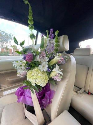 Florist's choice flower arrangement buckled in for transport.