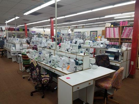 Sewing machines, coverstitch, overlock and serger sewing machines on display. Brother & Janome embroidery machines