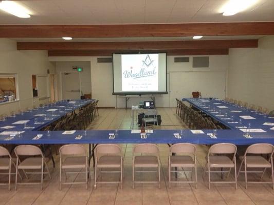 Dining hall at the Woodland Masonic Lodge with outside view of the full kitchen in the left of the photo