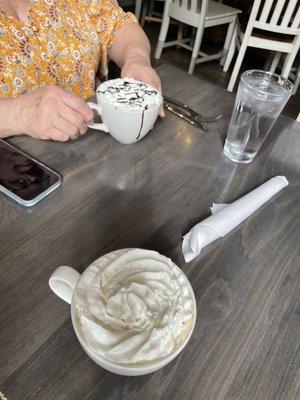 Toasted hot chocolate and white mocha both topped with whipped cream. Yum