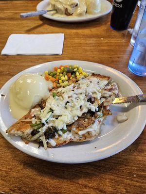 Chicken breast, onions, peppers with mashed potatoes gravy and vegetables