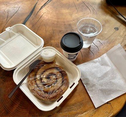 Cinnamon roll, coffee, old wood table