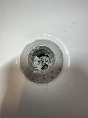 Thinset mortar dried up in bathtub drain.