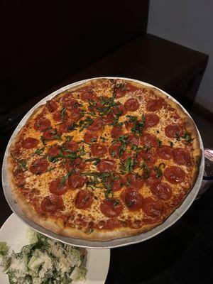 Pepperoni pizza with basil