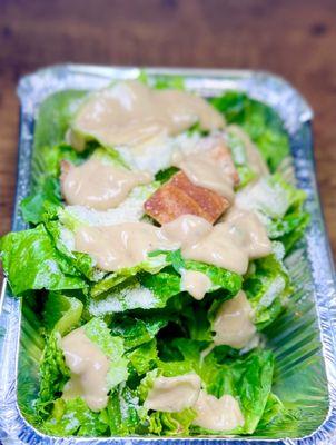 Caesar salad all dressed up - unusual Caesar dressing very savory - takeout