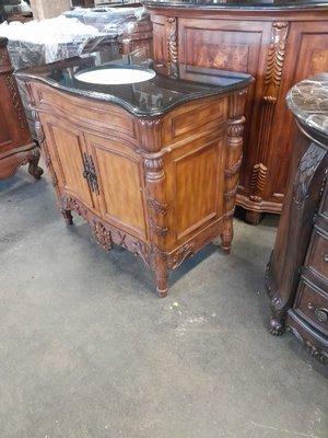 Another style of sink vanity with black marble top