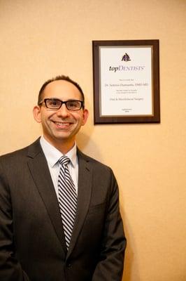 Dr. Diamantis in our Nashua waiting room beside his "Best Dentist" plaque.