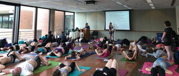 45 LMT individuals learning my Whole Body Fascia Rescue® Self-Care approach on a floor.