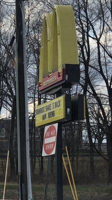 The irony of a "do not enter" sign in front of the McDonald's sign. My digestive system appreciates the warning.