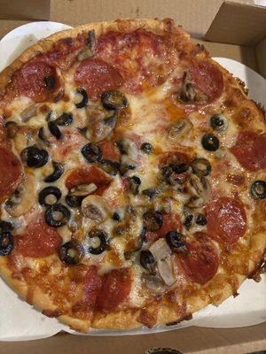 Small pizza with pepperoni and mushrooms and black olives