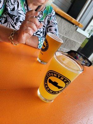 Beer Garden Tables with Witness the Citrus NEIPA and Cliff Jumper IPA. Each table has a QR Code to scan booth beer and food.