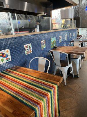 Indoor seating area plus view of the kitchen.