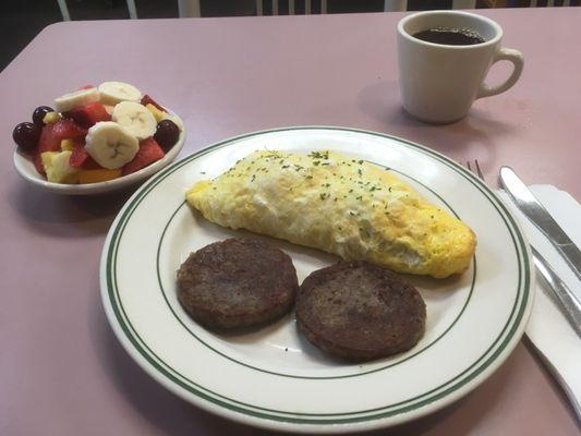 Steak and Swiss omelet, side of sausage patties and fruit.