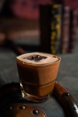 The Death Before Decaf: 
 Fresh brewed espresso, Irish cream, chocolate liqueur, aged dark rum, coffee liqueur, coconut liqueur.