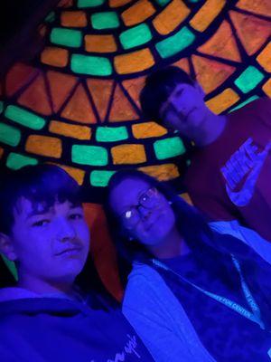 My kids and me playing the glow in the dark indoor course.