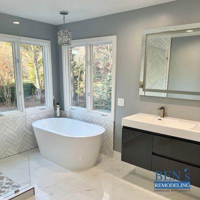 a remodeled bathroom , marble floor tiles,stand-alone tub , brushed nickel finish, double sink vanity