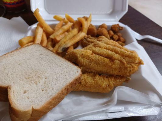 Three piece catfish dinner with French fries and okra.