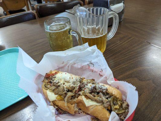 Small pitcher and a steak sub w onions, peppers mushrooms and cheese and toasted in the pizza oven.