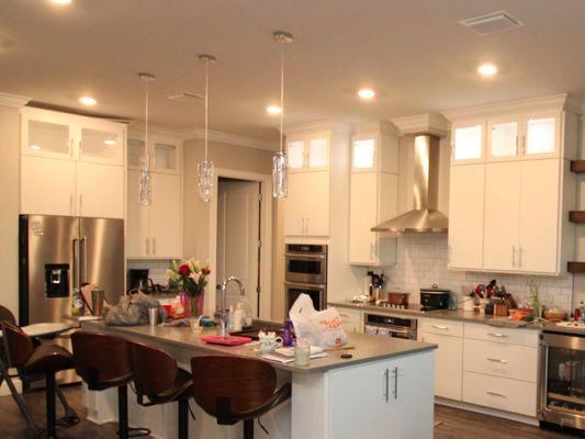 Custom Modern Kitchen Upper Cabinets Only with Wood Frame Glass Doors shown in Solid Bright White on Maple with LED Lights in Cabinets