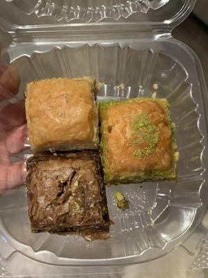 Three pieces of baklava- pistachio, walnut, and chocolate