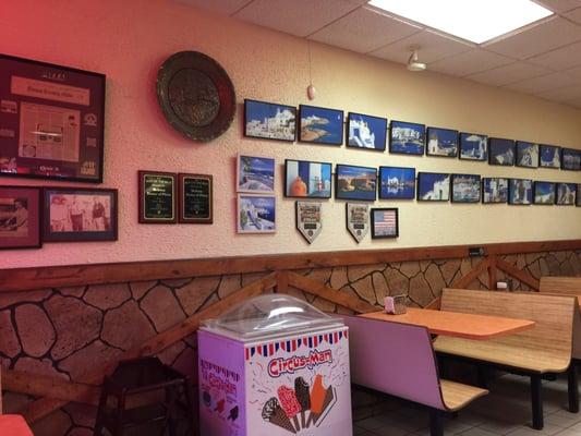 Basic interior for a pizza/sub shop except framed Greek photos. Smells pleasant and clean enough.