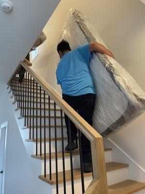 Carrying a customer's protected mattress upstairs