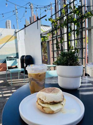 Salted maple sausage sandwich and iced vanilla latte with oatmilk