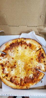 Small cheese pizza with fresh mozzarella.