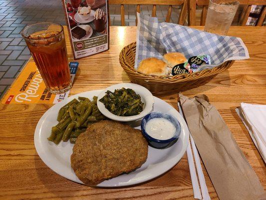 The country fried steak with green beans, turnip greens, biscuits, and an unsweet tea.