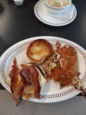 Cheeseburger with grilled onions, bacon & fried eggs. Hashbrowns on the side.