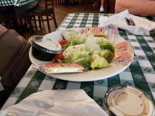 Tossed salad comes with crackers and dressing on the side.