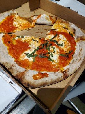 Margherita pizza, sloppy, wet, uncooked center, sauce tastes like tomato soup, barely any basil.