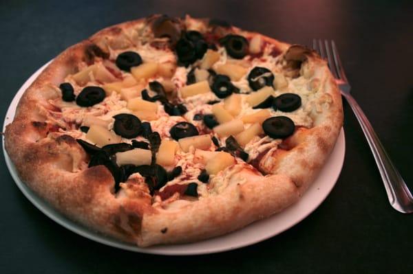 Vegan cheese pizza with black olives and pineapple. (They use Daiya!)