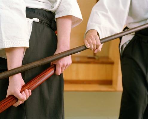 A jo (staff) and bokken (wooden sword) pin