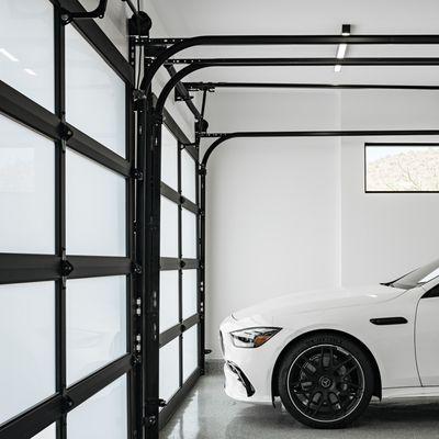 Custom garage doors, tinted glass, and powder coated hardware.