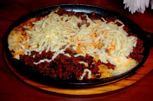 Delicious queso fundido served a la plancha