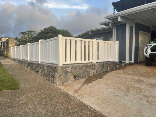 Blue rock wall with white vinyl fencing!