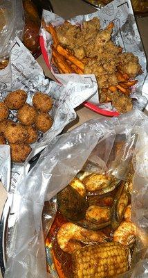 Whole shrimp&green mussels w/ eggs in buttery garlic sauce (extra extra fire) , hush puppies , fried oysters basket w/ sweet potato fries