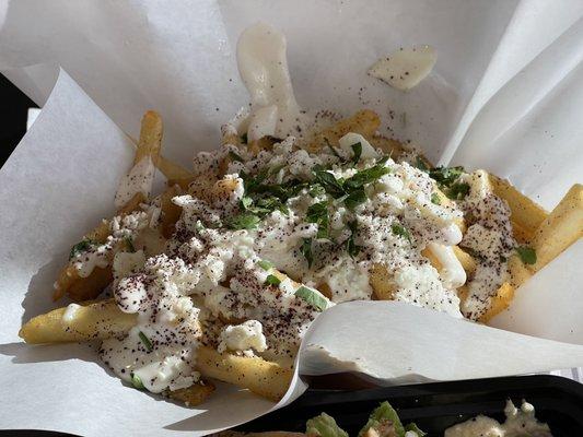 Order these Greek fries with garlic sauce and feta cheese!