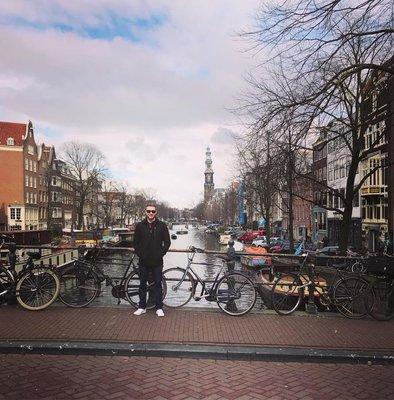 A Largay Travel advisor stopping to pose at one of Amsterdam's iconic canals.