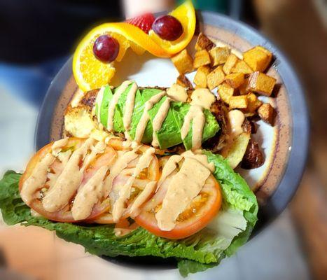 Grilled Chicken and Avocado Sandwich topped with Remoulade dressing.