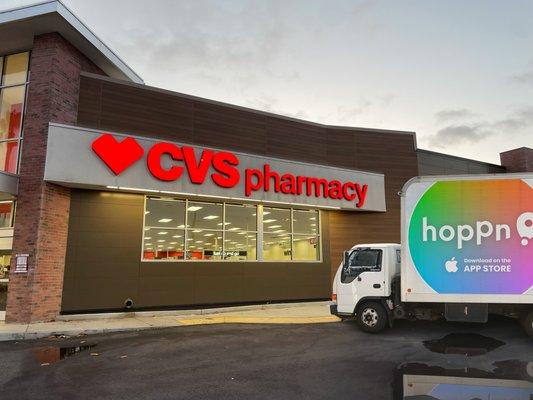 CVS pharmacy exterior at dusk. Hoppn truck parked out front.