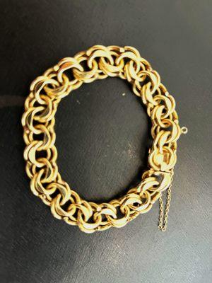 Hi.  We just spoke and this is the bracelet I want to sell.  It is 14k and weighs about 2ozs. on my food scale.