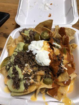 $5 Barbacoa nachos, added the red and green sauce myself. The thick chips were clutch.